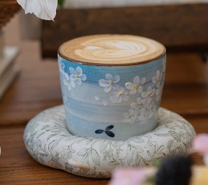 Hand-painted Jingdezhen ceramic coffee cup with white floral underglaze design on a blue background – traditional Chinese style handcrafted cup