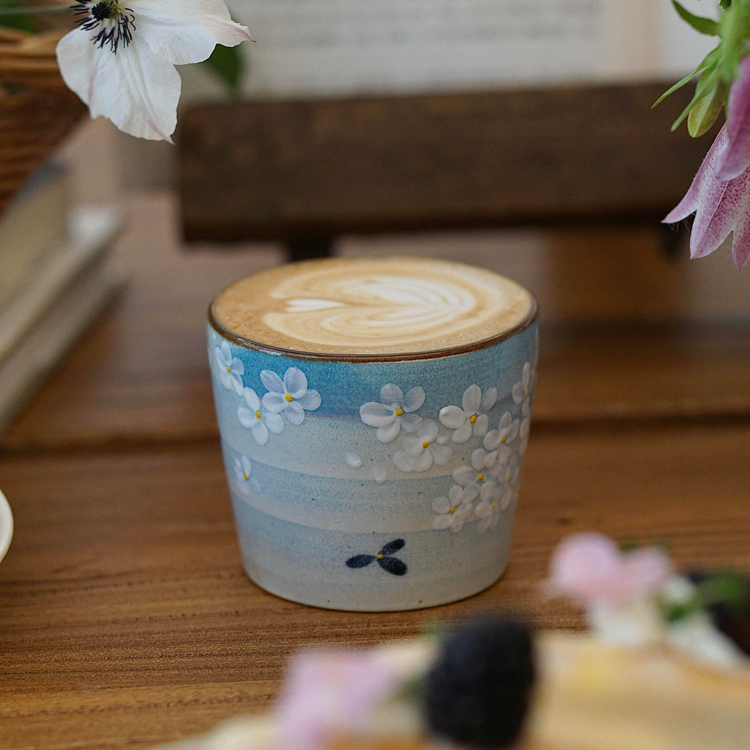 Hand-painted Jingdezhen ceramic coffee cup with white floral underglaze design on a blue background – traditional Chinese style handcrafted cup