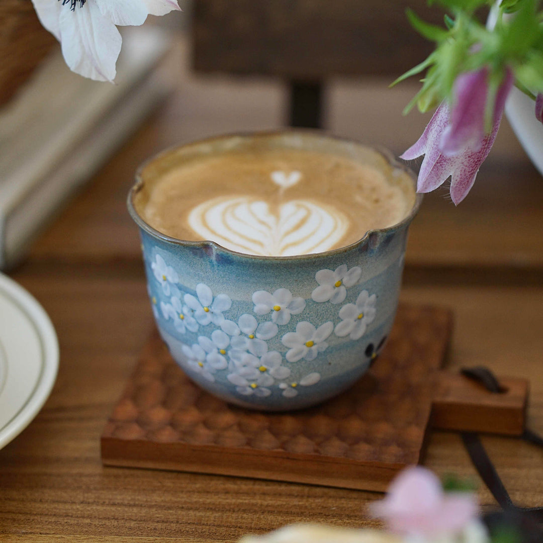 Hand-painted Jingdezhen ceramic coffee cup with white floral underglaze design on a blue background – traditional Chinese style handcrafted cup