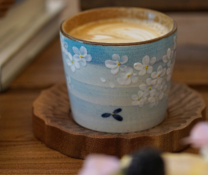 Hand-painted Jingdezhen ceramic coffee cup with white floral underglaze design on a blue background – traditional Chinese style handcrafted cup